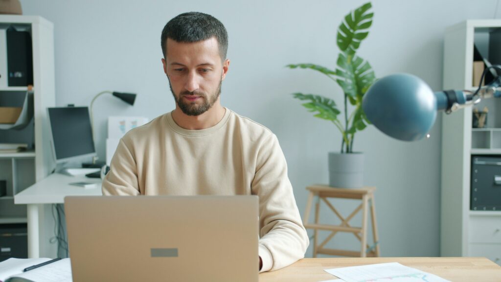 person laptop tax documents home